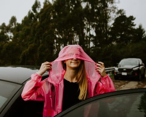A girl wearing a pink raincoat