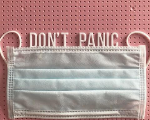 A face mask with a message saying "Don't panic."